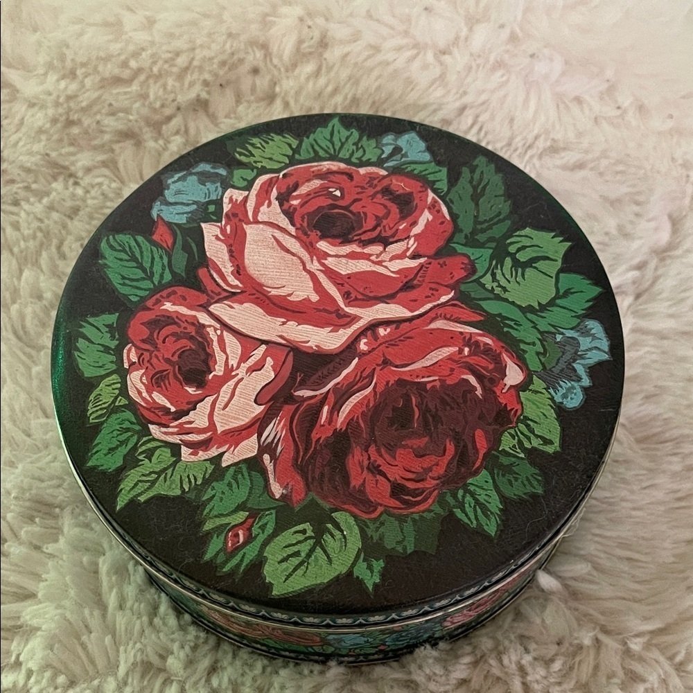 Vintage Floral Round Tin Box with something inside possibly fur knitting